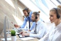 Phone operator working at call centre office helping hiss colleague Royalty Free Stock Photo