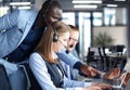 Phone operator working at call centre office helping hiss colleague Royalty Free Stock Photo