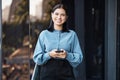 Phone, portrait and happy with a business woman typing a text message while standing outdoor on an office balcony Royalty Free Stock Photo