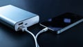 Phone power bank. Mobile phone or smartphone battery charging from portable powerbank with white usb cable. External Royalty Free Stock Photo