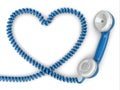 Phone reciever and cord as heart. Love hotline concept. Royalty Free Stock Photo