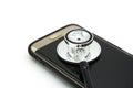 Phone repair and service concept.Smartphone being diagnosed with a stethoscope Royalty Free Stock Photo