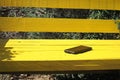 Phone resting on a bright yellow bench, lost smart phone concept Royalty Free Stock Photo