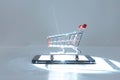 Phone screen emitting light on bright white background with shopping cart AI Image Royalty Free Stock Photo