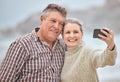 Phone, selfie and beach with a senior couple taking a photograph while on holiday or vacation travel together. Mobile Royalty Free Stock Photo