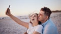 Phone selfie, love and relax couple on the beach have outdoor fun, laugh and enjoy quality bonding time together. Happy Royalty Free Stock Photo