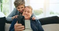 Phone, senior or happy couple on social media on couch for communication, meme or internet connection. Home, mature man