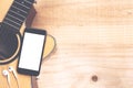 Phone showing screen on guitar top view music concept Royalty Free Stock Photo