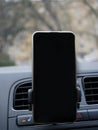 Phone on the stand in the car, Navigator, mock up, copy space Royalty Free Stock Photo