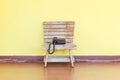 Phone stands on a wooden chair Royalty Free Stock Photo