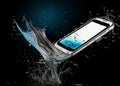 The phone is surrounded by water. Royalty Free Stock Photo