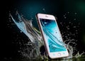The phone is surrounded by water. Royalty Free Stock Photo
