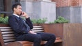 Phone Talk, African Businessman Attending Call while Sitting on Bench Royalty Free Stock Photo