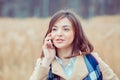 Phone talk. Closeup portrait. Happy woman talking on mobile phone outside outdoors on autumn park background, professional Royalty Free Stock Photo