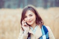 Phone talk. Closeup portrait. Happy woman talking on mobile phone outside outdoors on autumn park background, professional Royalty Free Stock Photo