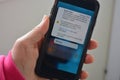 Phone with text message from UK government, testing Severe Alert for use in emergency