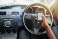 Phone, texting and driving with hands of person on steering wheel with scroll, danger and risk. Road safety, awareness Royalty Free Stock Photo