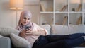 Phone texting woman internet resting sofa home Royalty Free Stock Photo