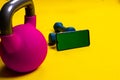 Dumbbells space kettlebell yellow phone lue isolated background cast, for lifting dumbbell from barbell and strength Royalty Free Stock Photo