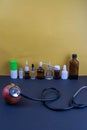The phonendoscope listens to the apple. The concept of health in the background is a bottle with medicines Royalty Free Stock Photo