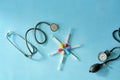 Phonendoscope stethoscope, sphygmomanometer, vacuum test tubes on blue background.