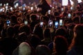 Phones of crowded people at the concert.