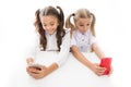 Phones designed for learning. Small kids having video lesson on mobile phones. Little girls using camera in their phones Royalty Free Stock Photo