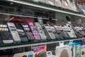 Phones new and retro through shop`s showcase. Mobiles evolution from keypad to touchpad on store`s shelves