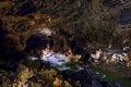 Phong Nha Ke national park / Vietnam, 16/11/2017: Group of cavers passing an underground river and huge rocks inside the giant Royalty Free Stock Photo