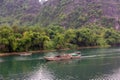 A boat traveling down a river in the village of Phong Nha in Vietnam