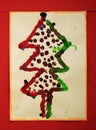 Photo of an actual christmas tree prepared and painted by a child