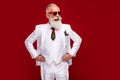 Photo of adorable attractive age gentleman wear new year costume eyewear arms waist empty space isolated red color