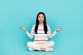 Photo of adorable calm peaceful young woman practice mindfulness open her chakras isolated on turquoise color background