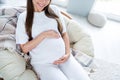 Photo of adorable charming cute lovely pregnant girl sitting in soft chair enjoying pregnancy waiting childbirth white Royalty Free Stock Photo