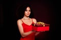 Photo of an adorable classy sexual lady celebrating xmas presenting gift isolated on dark red color background Royalty Free Stock Photo