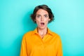 Photo of adorable cute nice girl with bob hairdo dressed yellow shirt scared horrified staring isolated on turquoise