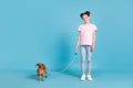 Photo of adorable cute school girl wear pink t-shirt smiling walking small friend isolated blue color background