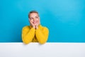 Photo of adorable dreamy lady hand touch cheeks face interested look empty space isolated on blue color background