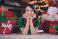 Photo of adorable dreamy young lady wear elf clothes lying floor arms cheeks smiling indoors house home room Royalty Free Stock Photo