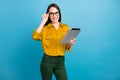 Photo of adorable intelligent lady wear yellow shirt spectacles working modern gadget isolated blue color background