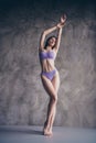 Photo of adorable lovely gentle woman posing with raised hands wearing stylish lingerie isolated on grey concrete wall Royalty Free Stock Photo