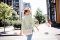 Photo of adorable optimistic girl dressed in sstylish clothes handbag going store mall nice weekend pastime alone