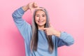 Photo of adorable pretty retired woman blue sweater showing fingers photo shot isolated pink color background Royalty Free Stock Photo