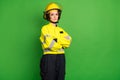 Photo of adorable reliable young fire lady workwear yellow helmet arms folded empty space isolated green color