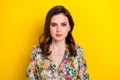 Photo of adorable serious confident woman dressed vintage flower print blouse isolated yellow color background Royalty Free Stock Photo