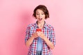 Photo of adorable shocked young woman wear checkered shirt looking writing modern gadget isolated pink color background