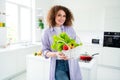 Photo of adorable sweet woman wear violet shirt bringing home fresh market veggies indoors apartment kitchen