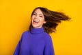 Photo of adorable sweet young lady dressed violet sweater laughing wind blowing hair t isolated yellow color background Royalty Free Stock Photo
