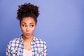 Photo of adorable tricky young woman wear plaid shirt lips pouted looking empty space isolated violet color background