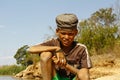 Photo of adorable young happy boy - african poor child on the ri Royalty Free Stock Photo